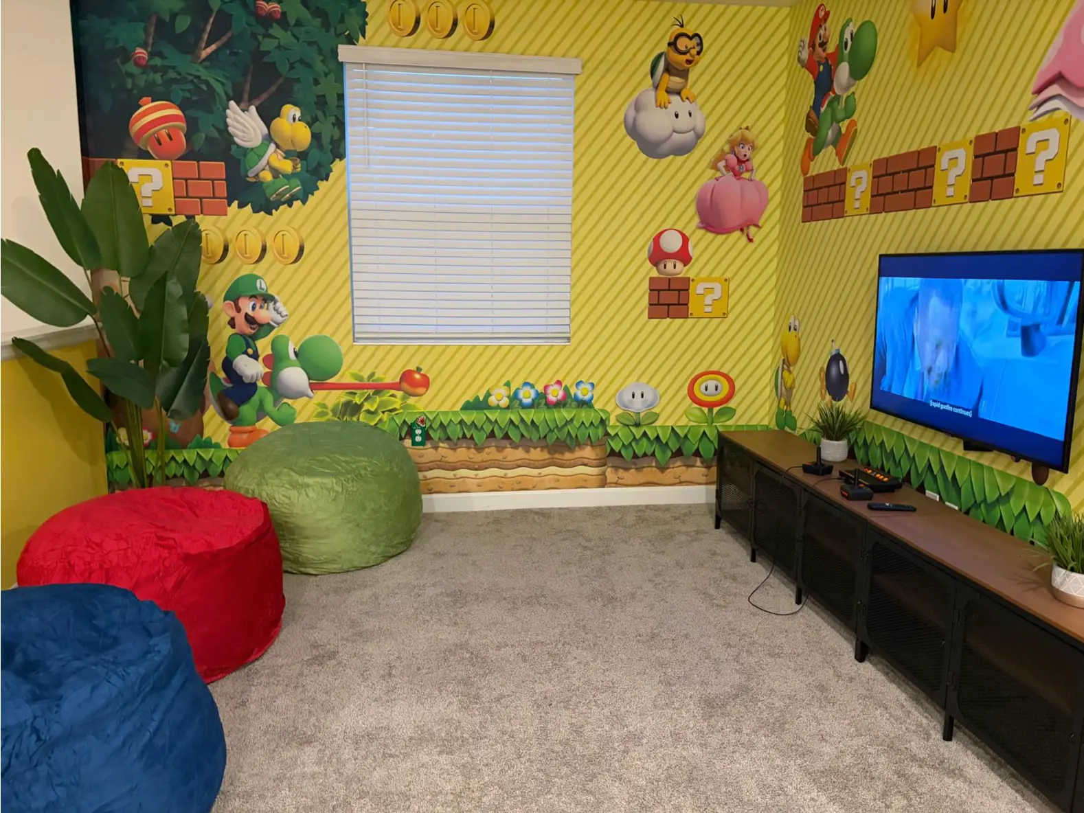 Themed lounge with printed wallpaper, plants, cutouts and colorful bean bags