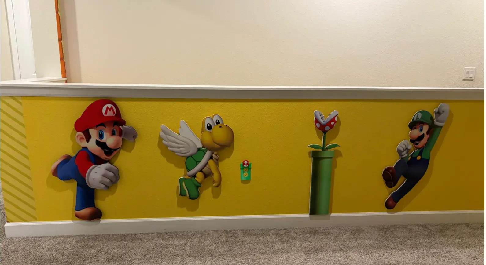 Yellow printed wall band with character cutouts along a hallway