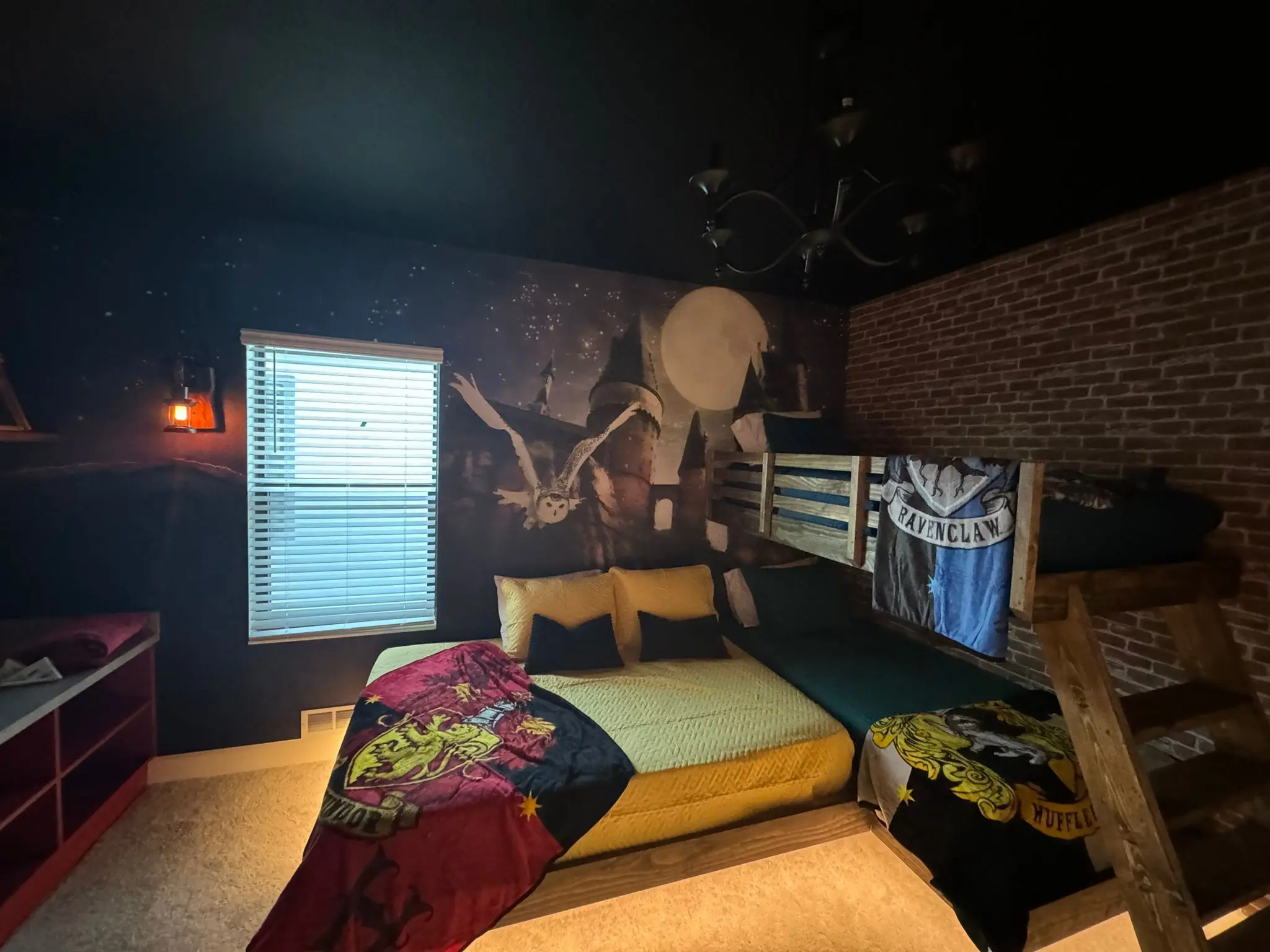 Themed bedroom with a castle mural under a full moon and a brick-effect wall
