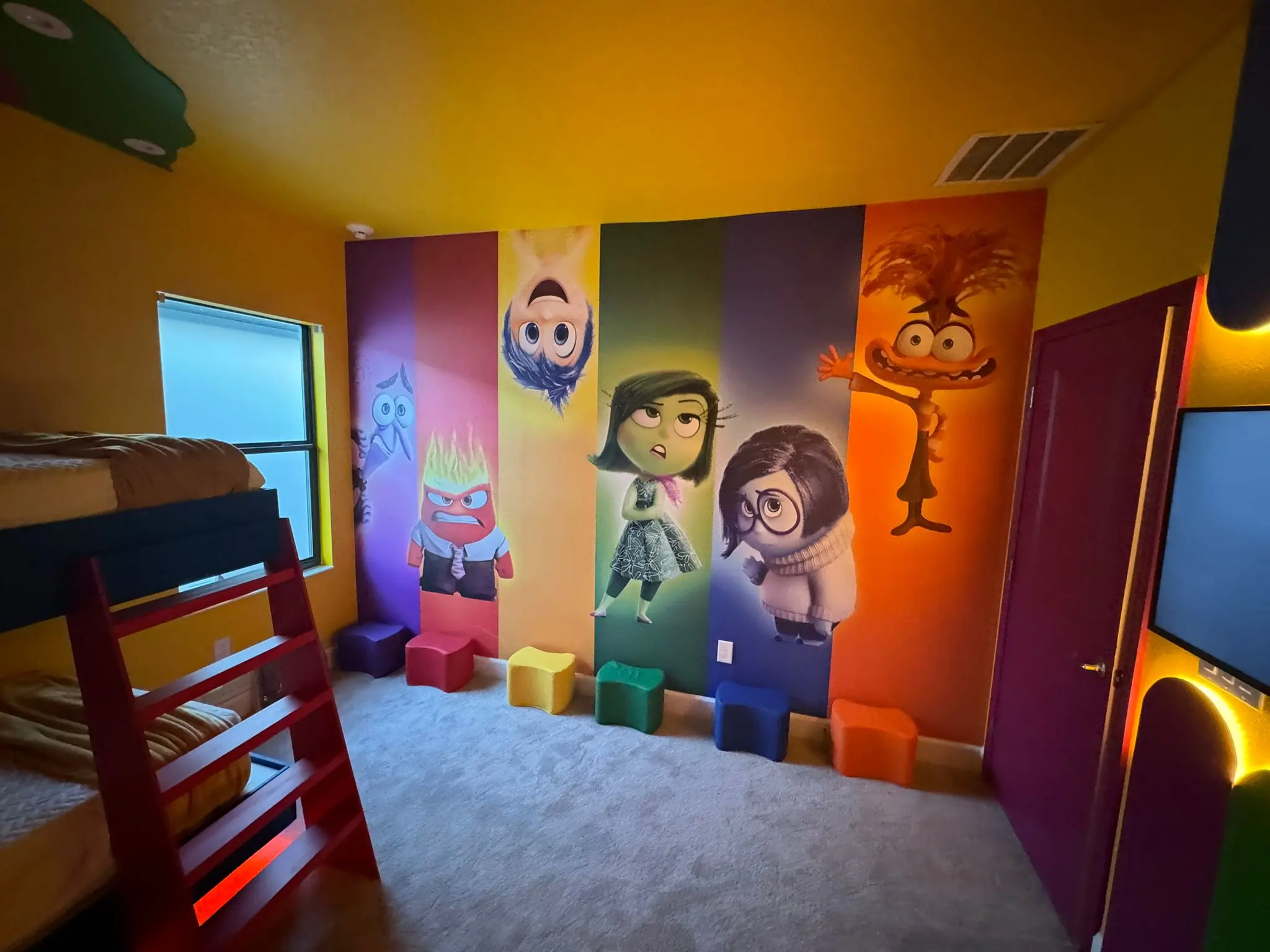 Bright themed kids' room with a wall mural in vertical color bands
